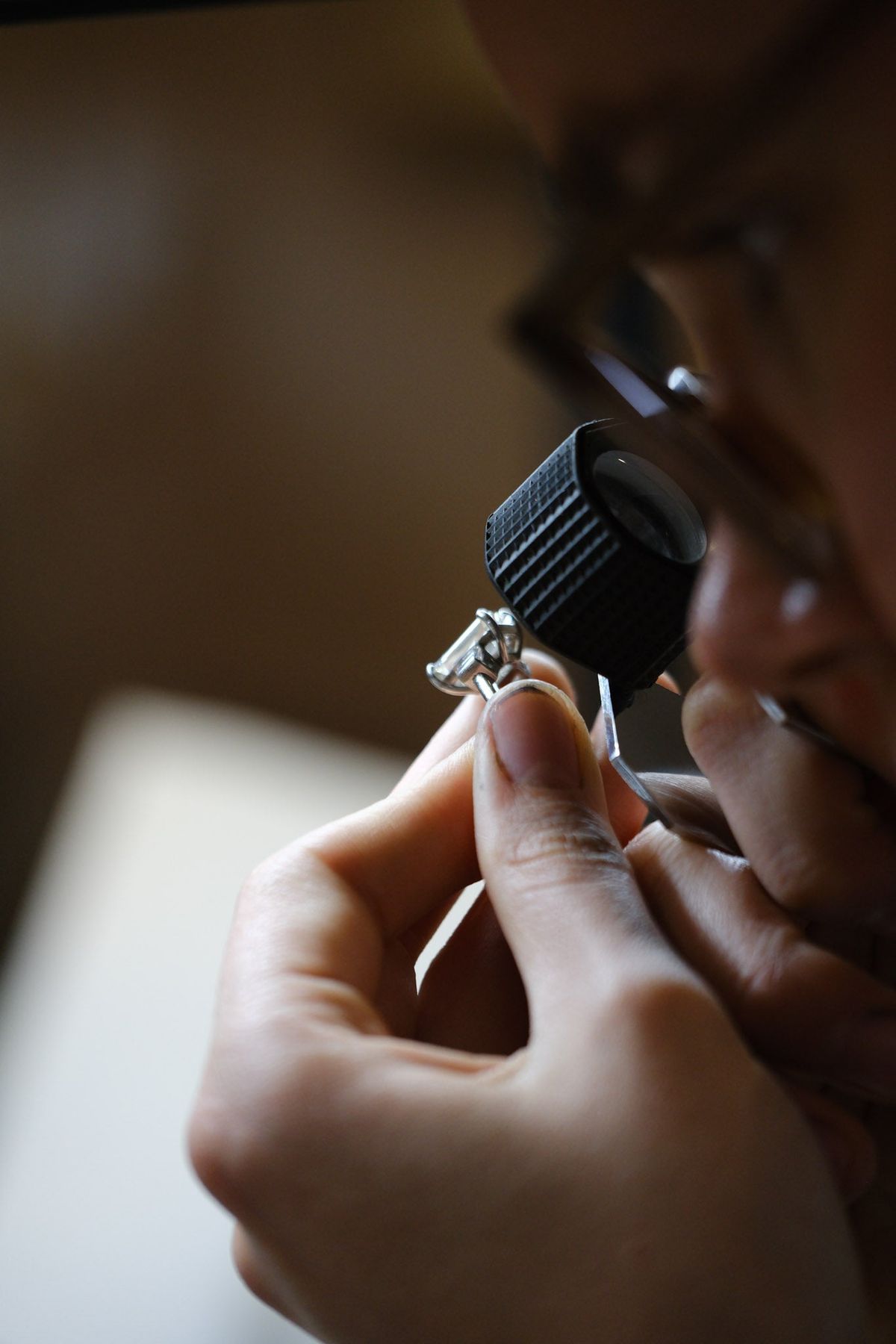 A jeweler inspecting a ring setting under magnification